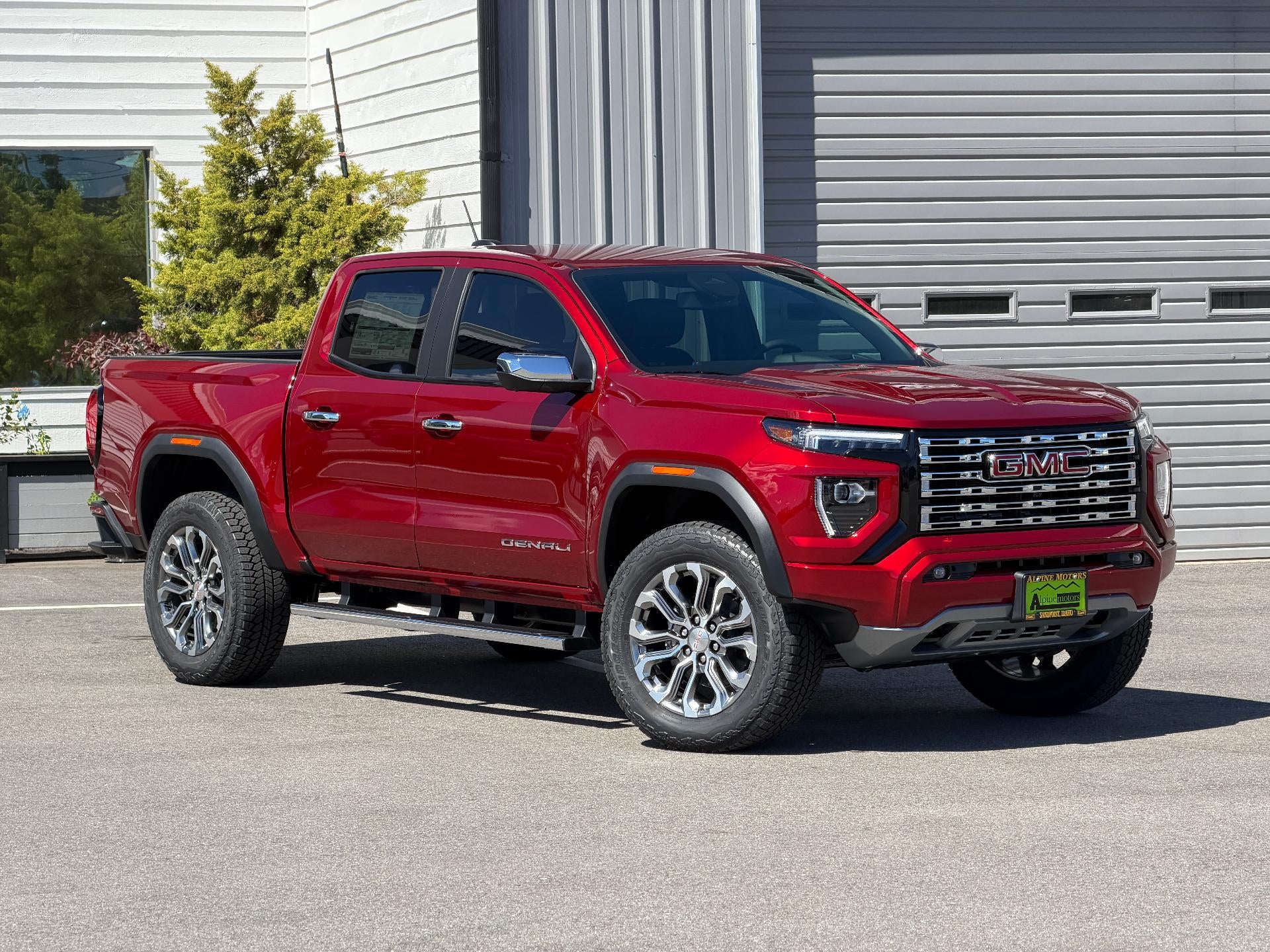 2026 GMC Canyon Crew Cab Short Box 4-Wheel Drive Denali in Volcanic Red Tintcoat — front three-quarter view